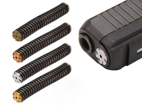 Four NDZ guide rod assemblies beside a Glock slide with one installed